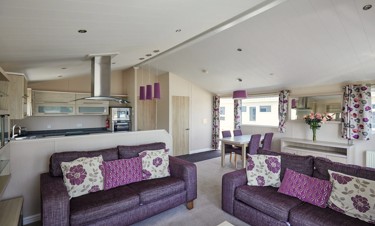 Representation of a kitchen, lounge and dining area in a Emerald Lodge