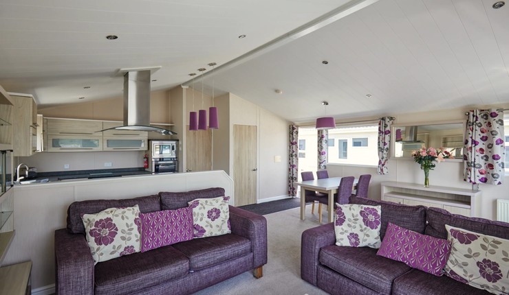 Representation of a kitchen, lounge and dining area in a Emerald Lodge