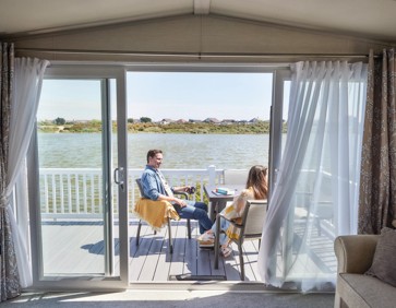The owners' relaxing on the deck of their caravan