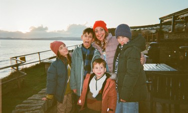 Family dressed in warm clothes on the beach
