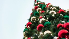 Baubles adorn a festive Christmas tree.