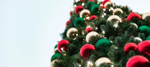 Baubles adorn a festive Christmas tree.