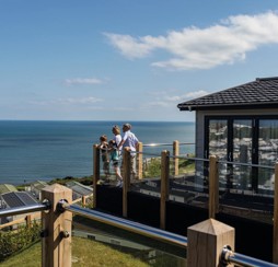 A family check out the sea views from the Lodge's deck in Devon Cliffs.