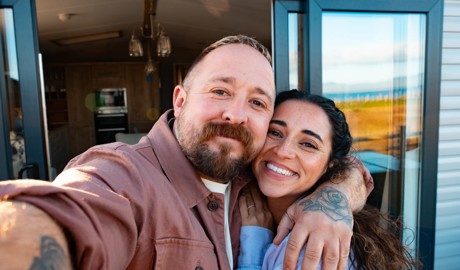 A couple outside their holiday home. 