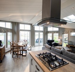 Looking out onto one of Haggerston Castle's lakes from inside a lodge holiday home.