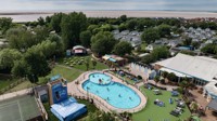 An aerial view of Burnham-on-Sea's Adventure village, with the coastline just visible behind it.