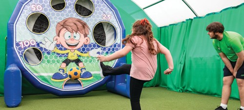 Children between 5-12 years playing football together with Football Fun Factory.