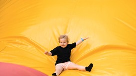 The red, blue and yellow inflatable arena is shown in front of Haggerston Castle, on Haven's Haggerston Castle Holiday Park, Northumberland