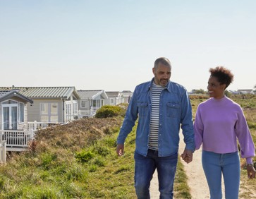 A family enjoy a nature walk at Church Farm Holiday Park, Sussex.