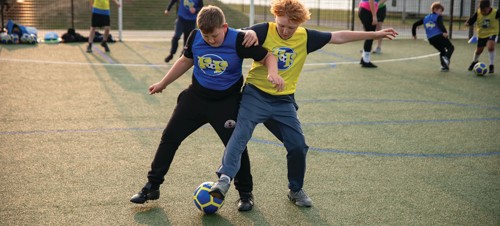 Children between 5-12 years playing football together with Football Fun Factory.