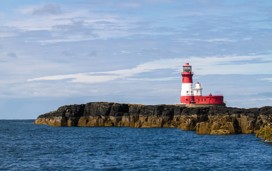 A view of a Longstone Lighthouse overlooking the sea in Northumberland.