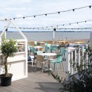 The decked outdoor terrace area at Kent Coast Yacht Club looks out over the Thames estuary.