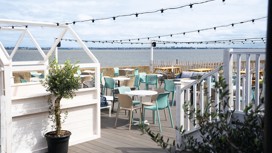 The decked outdoor terrace area at Kent Coast Yacht Club looks out over the Thames estuary.