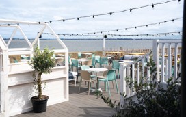 The decked outdoor terrace area at Kent Coast Yacht Club looks out over the Thames estuary.