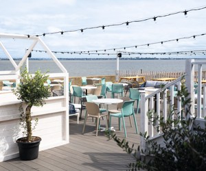 The decked outdoor terrace area at Kent Coast Yacht Club looks out over the Thames estuary.