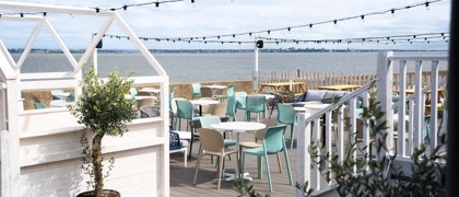 The decked outdoor terrace area at Kent Coast Yacht Club looks out over the Thames estuary.
