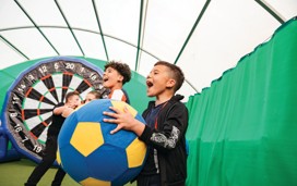 Chidren playing Football Fun Factory Dartboard challenge