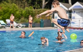 A boy jumps into the outdoor pool at Haven's Wild Duck, Norfolk.
