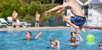 A boy jumps into the outdoor pool at Haven's Wild Duck, Norfolk.
