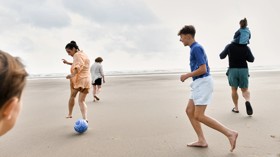 A family play together on the beach at Haven Greenacres.