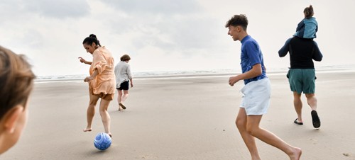 A family play together on the beach at Haven Greenacres.