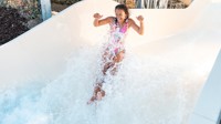 A teenage girl tests out the new Atlantis Falls water slide at Haven's Kent Cost holiday park.
