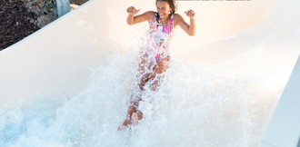 A teenage girl tests out the new Atlantis Falls water slide at Haven's Kent Cost holiday park.