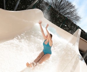 A teenage girl tests out the new Atlantis Falls water slide at Haven's Kent Cost holiday park.