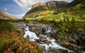 A scenic view of the Glencoe Highlands in Scotland during the day