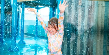 A young girl runs through the water features in Kent Coast's water park.