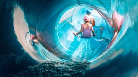 Children going down a water slide.