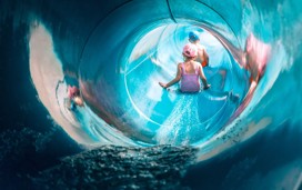 Children going down a water slide.
