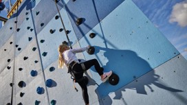 Helmet and ropes at the ready before you take to the climbing wall