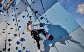 Helmet and ropes at the ready before you take to the climbing wall