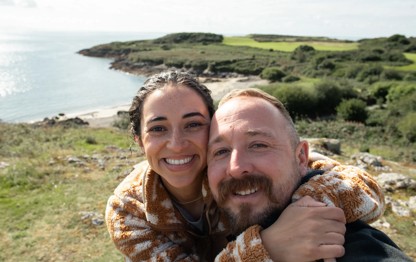 Couple taking a selfie at the sea near Hafan y Mor