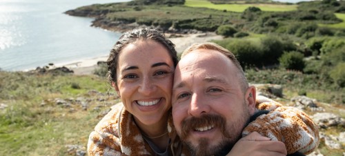 Couple taking a selfie at the sea near Hafan y Mor