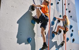 Helmet and ropes at the ready before you take to the climbing wall