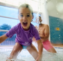 A dad and daughter play together in the pool at Primrose Valley, Yorkshire.