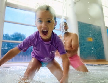 A dad and daughter play together in the pool at Primrose Valley, Yorkshire.