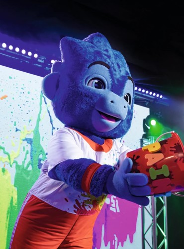 George throws glitter out from the stage