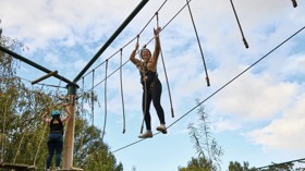A teenage girl tackles aerial obstacles at Primrose Valley, Yorkshire.