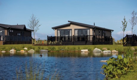 A Lodge next to a lake on our Haggerston Castle Holiday Park.