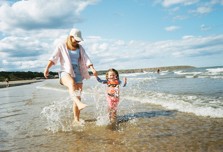 mum and tot in the sea on the beach