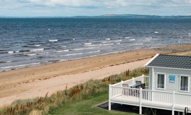 Representation of the view and the wraparound deck in a Signature Gold caravan at Craig Tara