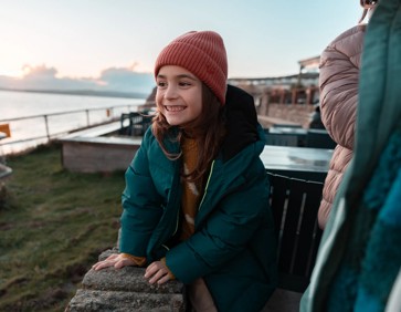 A family enjoys the incredible scenic views from their Devon Cliffs caravan.
